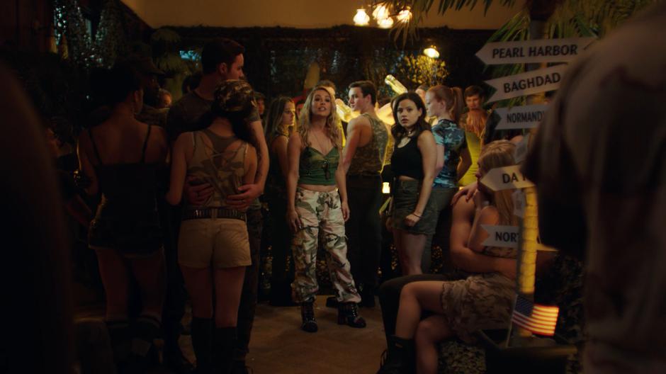 Lucy stops her conversation with Maggie in the middle of the party to remind everyone about the anti-alcohol policy.