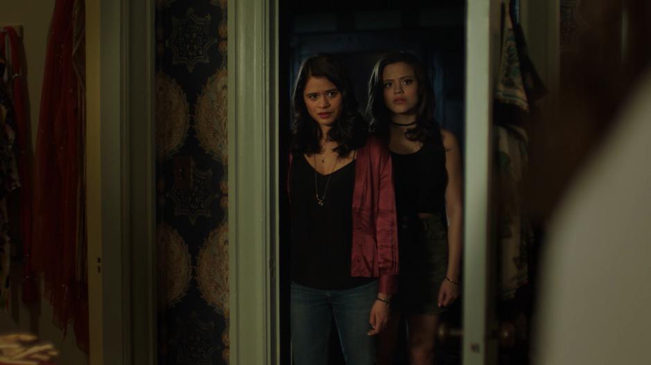 Mel and Maggie step into the doorway of of their mother's room.