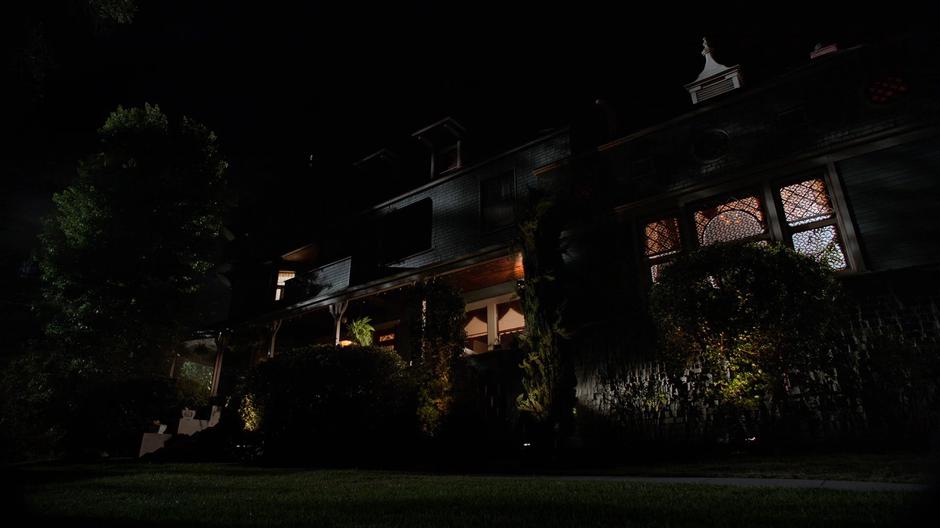 Establishing shot of the exterior of the house in the night.
