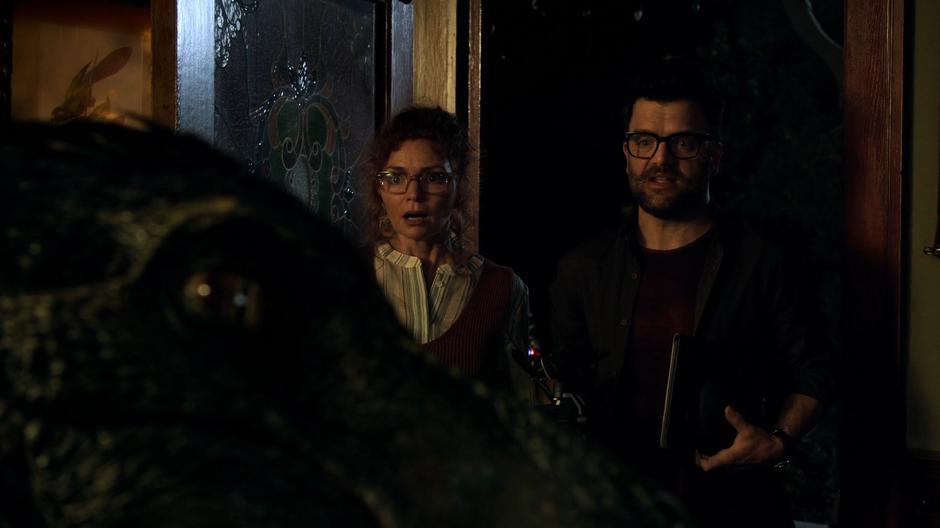 Stacey and Dale enter through the front door and are suprised to see the dinosaur under Gert's control.