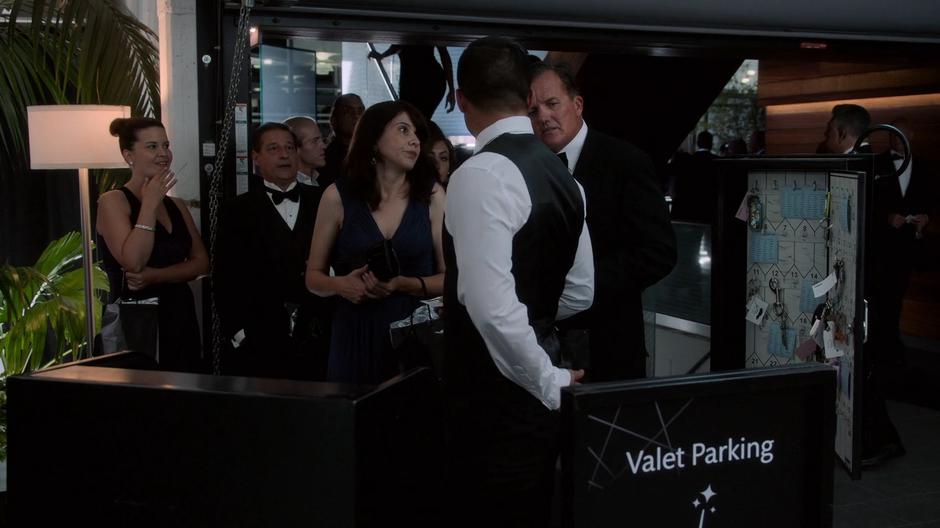 People talk to the valet on their way out of the party.