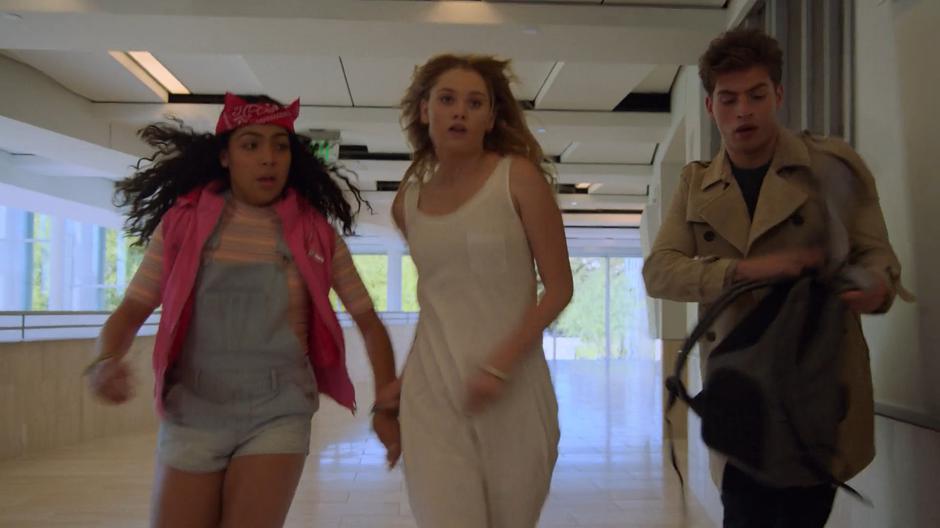 Molly, Karolina, and Chase run down the hallway to escape.