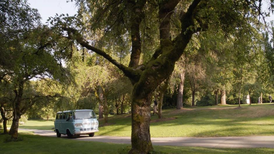 Ray drives the van with the band through the road in the park.