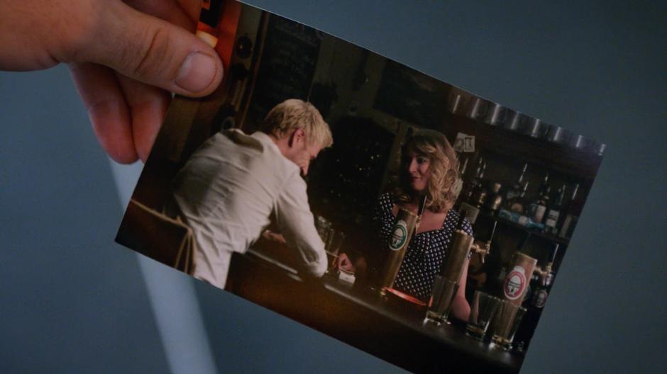 Zari gives Constantine a photo of him talking with his mother at the bar.