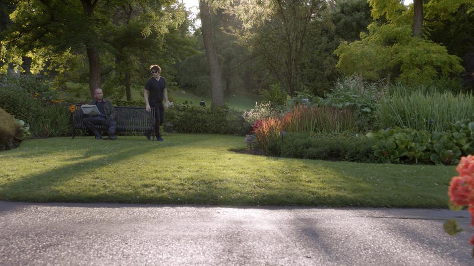 Ray walks around the bench in his attempt at a covert meeting with Mick.