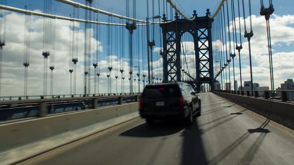 The FBI SUV speeds across the mostly deserted bridge with its lights flashing.