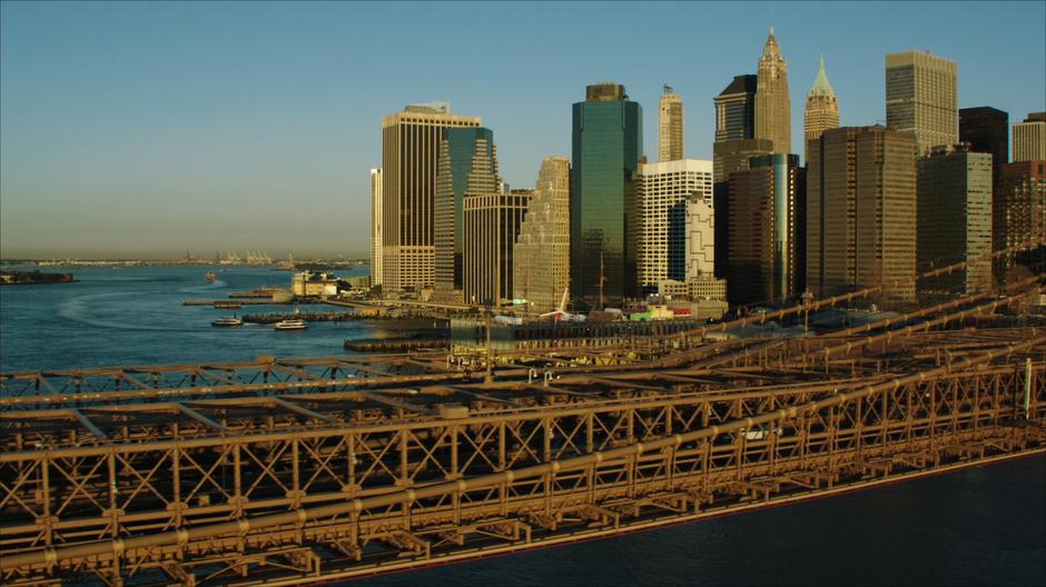 Sam jogs across the bridge towards Manhattan which looms in the background.
