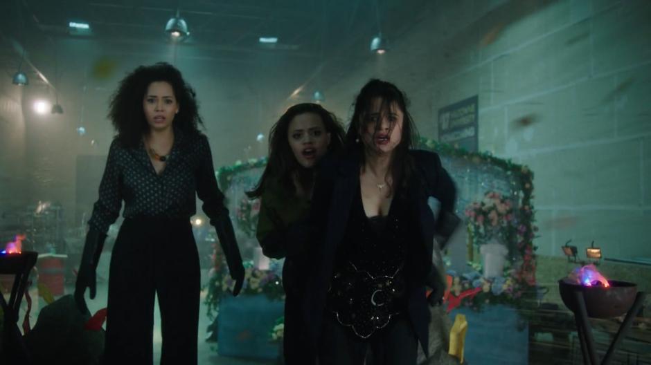 Macy, Maggie, and Mel watch as the demon is expelled from Angela Wu.