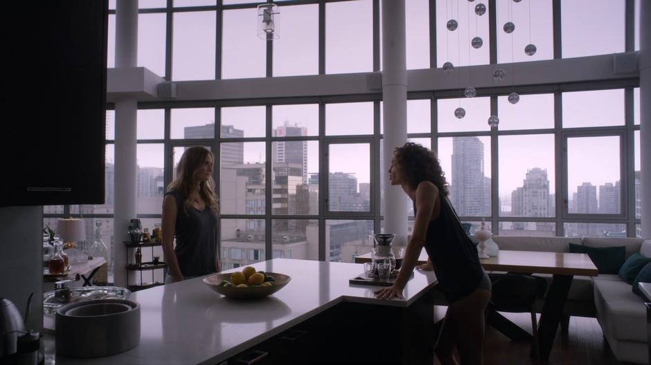Kylie yells at Emma while leaning against the kitchen counter.