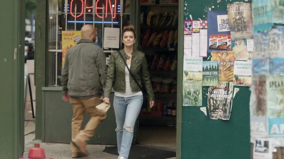Izzy walks out of the corner store and sees her father waiting across the street.