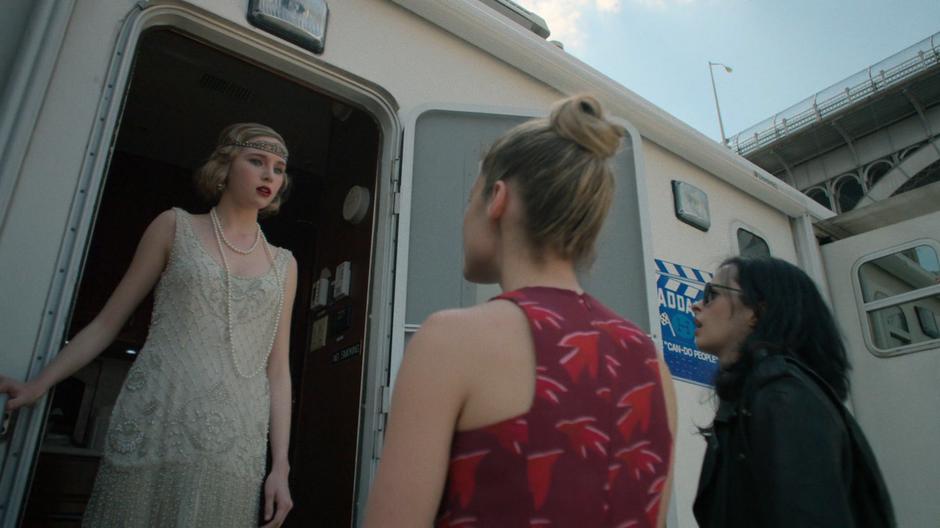 Trish and Jessica talk to Kelly Scott at the door of her trailer.