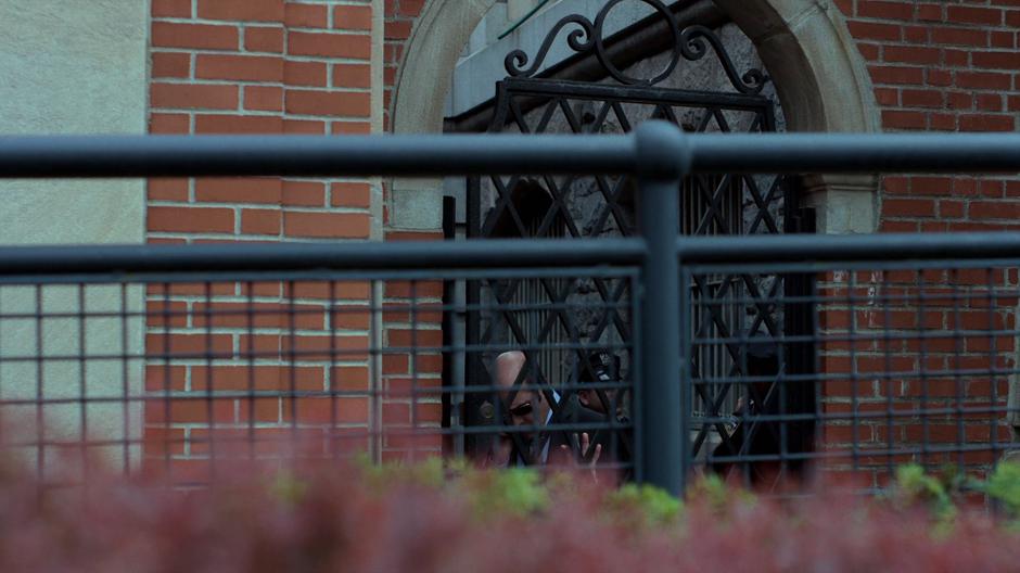 Detective Costa talks to Jessica on the phone while exiting the station through a side gate.