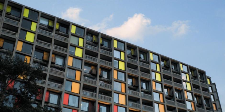 Establishing shot of the exterior of the block of flats.