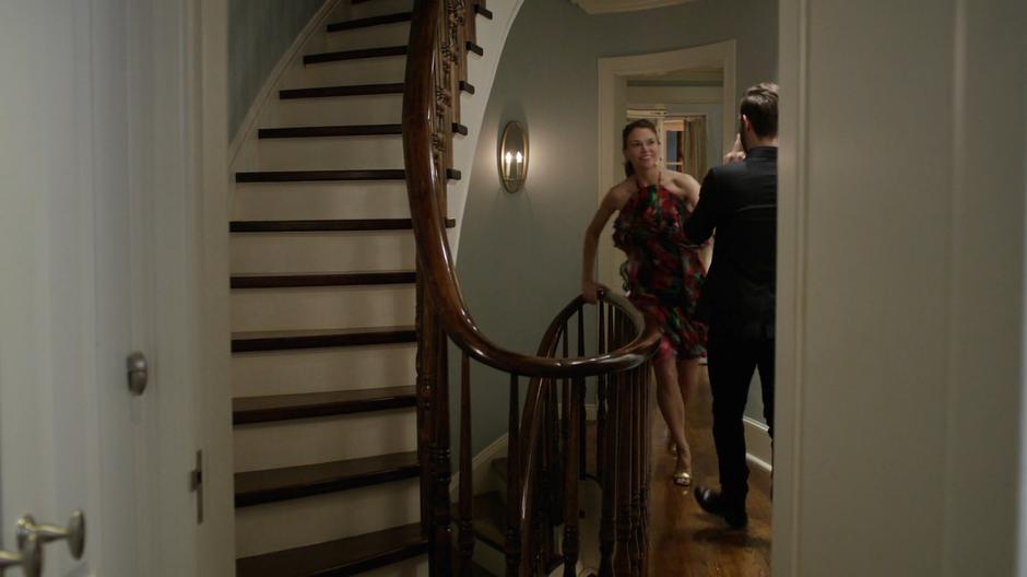 Liza walks up the stairs where Josh is waiting.