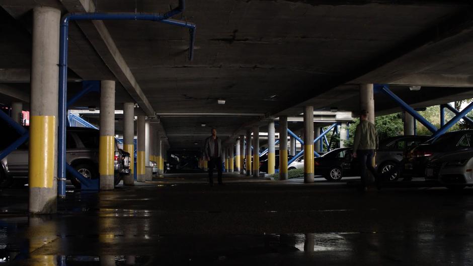 James walks over to Tom in the parking garage's lower level.