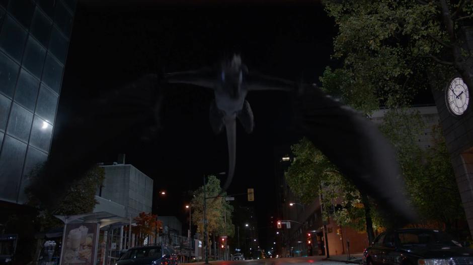 The dragon Spike flies down to the street.