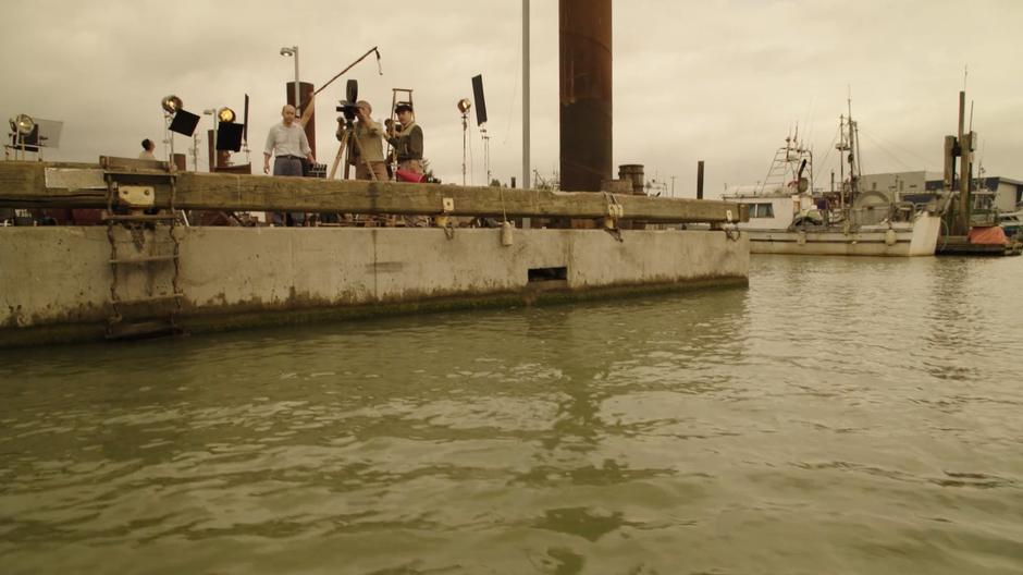 Ishiro Honda directs a scene being filmed off the side of the dock.