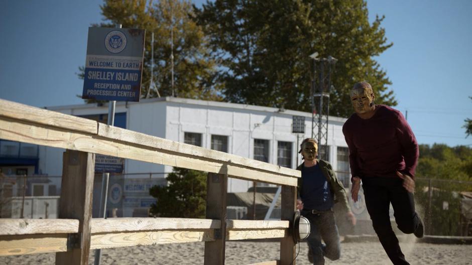 Tom and James run out onto the dock while wearing Children of Liberty masks.