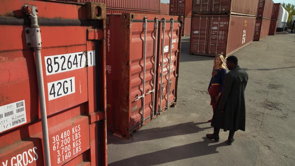 Kara and Manchester stand in front of the container identified in the tip Manchester received.