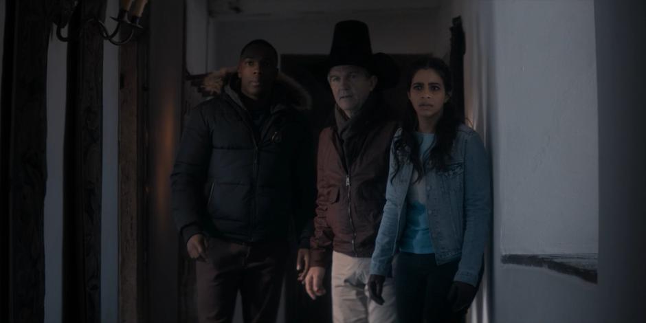 Ryan, Graham, and Yasmin watch as mud zombies walk down the hallway.