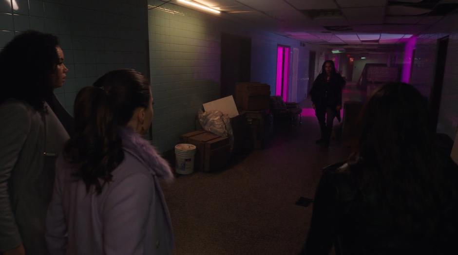Macy, Maggie, and Mel stop as Jada faces them down the hallway.