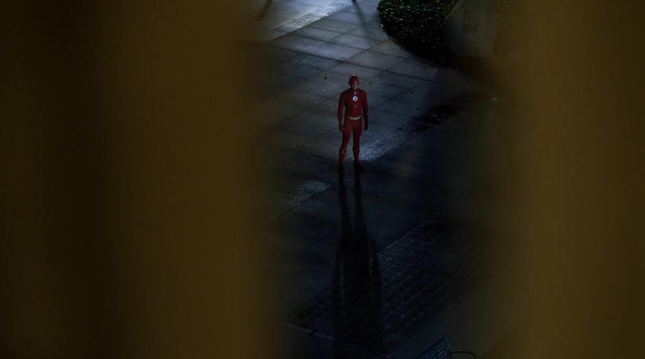 Barry stands in the plaza outside the hospital looking up at Grace's room.