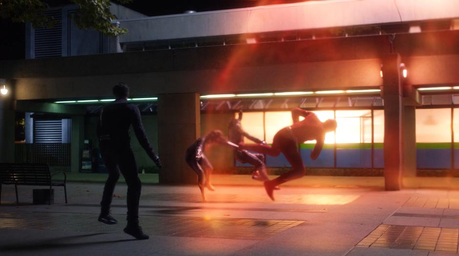 Ralph, Nora, Cisco, and Barry are thrown through the air by the blast from Cicada's dagger.