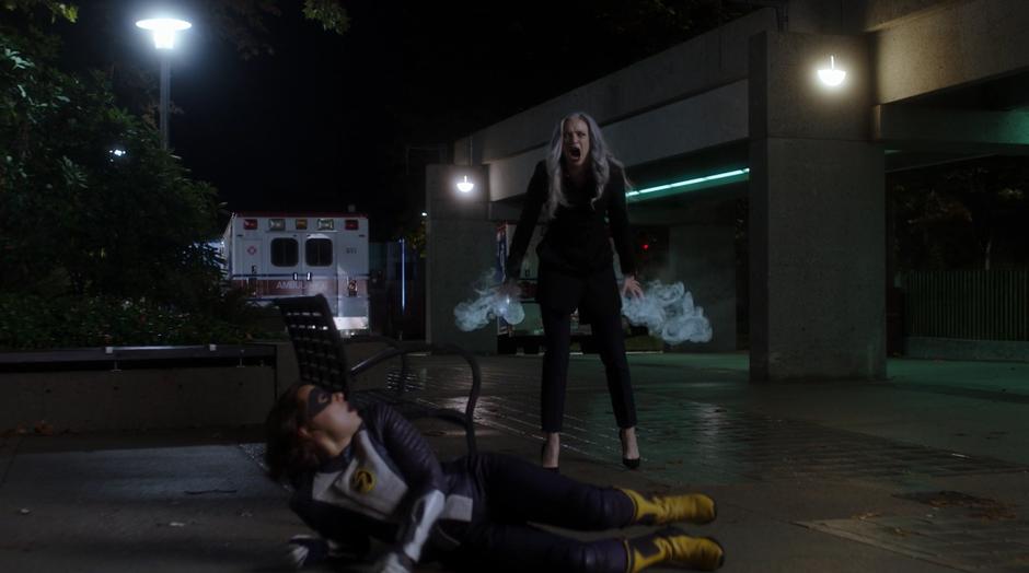 Killer Frost screams at Cicada while standing behind Nora who is on the ground.