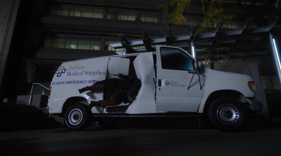 Cicada is thrown back into the side of a medical supply van.