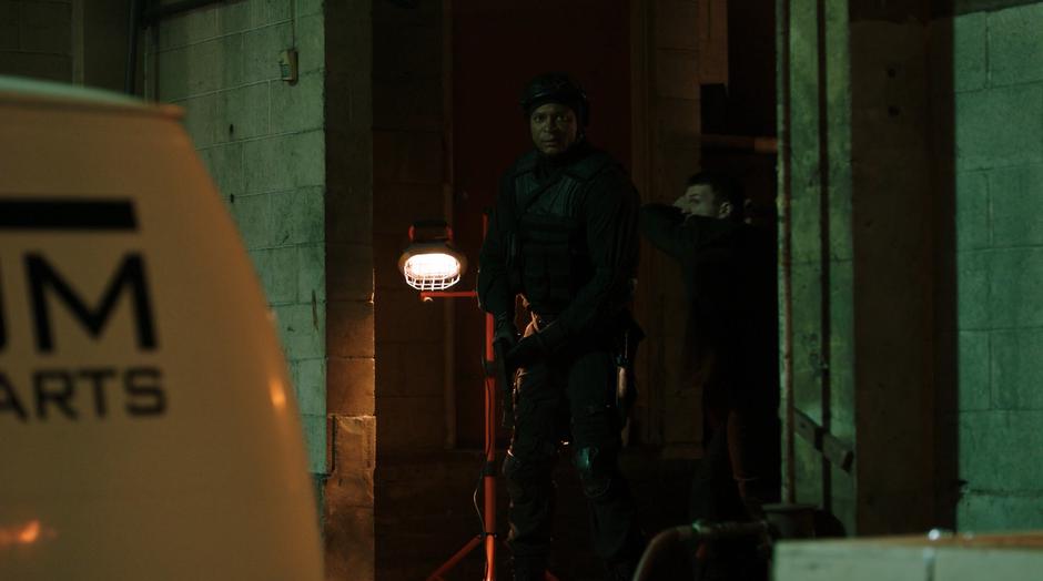 Diggle is looking out at Barry when another goon comes up behind him.