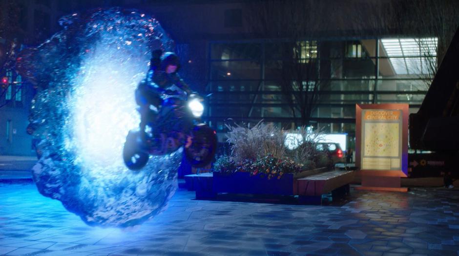 Barry drives Oliver's motorcycle out of a breach back onto Earth-1.