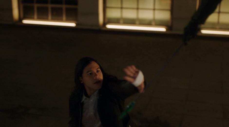 Cisco reaches for an arrow from Barry to attach the hacking device.