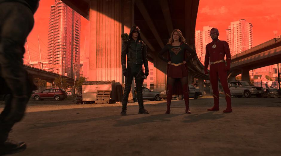 Barry, Kara, and Oliver stand in front of Diggle after taking car of his problem.
