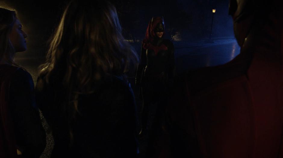 Kate Kane as Batwoman tells the others to leave town.