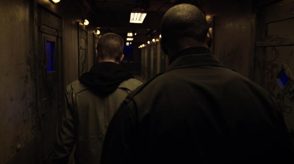 Oliver and Diggle search down the hallway for Dr. Deegan's office.
