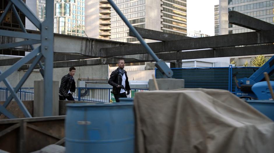 Barry and Oliver run through the construction site.