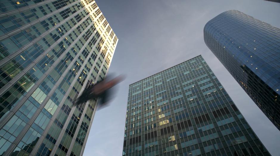 Superman flies overhead past the children.