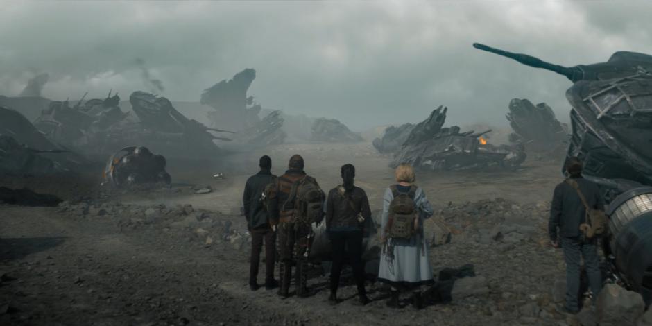 Ryan, Paltraki, Yaz, the Doctor, and Graham look out at the destroyed ships that came before.