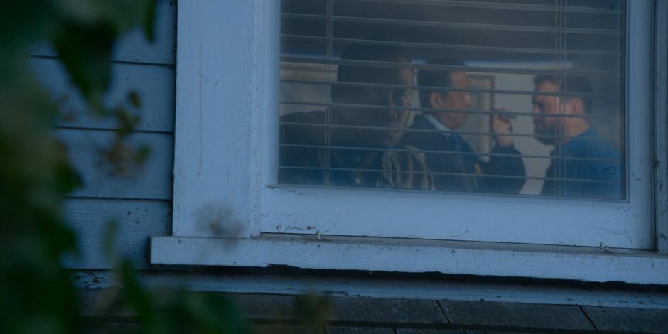 Jeff looks out the window and sees Grace talking to one of the FBI agents.