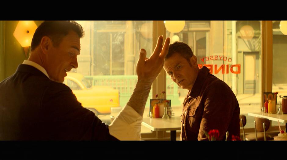 Jonah shows Victor his decaying arm while they talk in the diner.