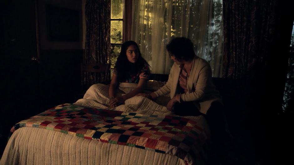 Graciela Aguirre sits on the bed with Molly and talks to her.