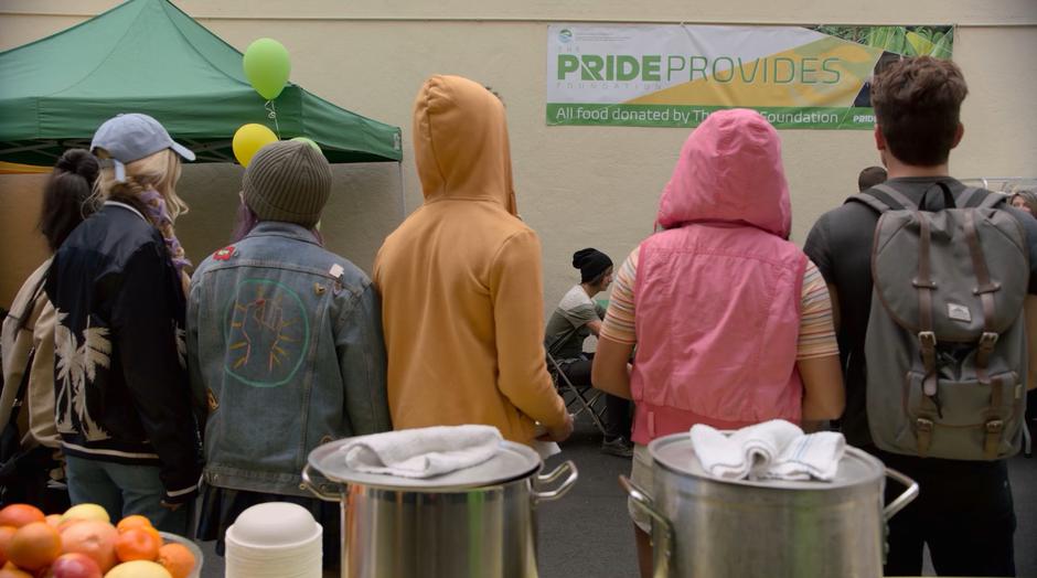The Runaways turn around and see the PRIDE banner hanging on the wall.