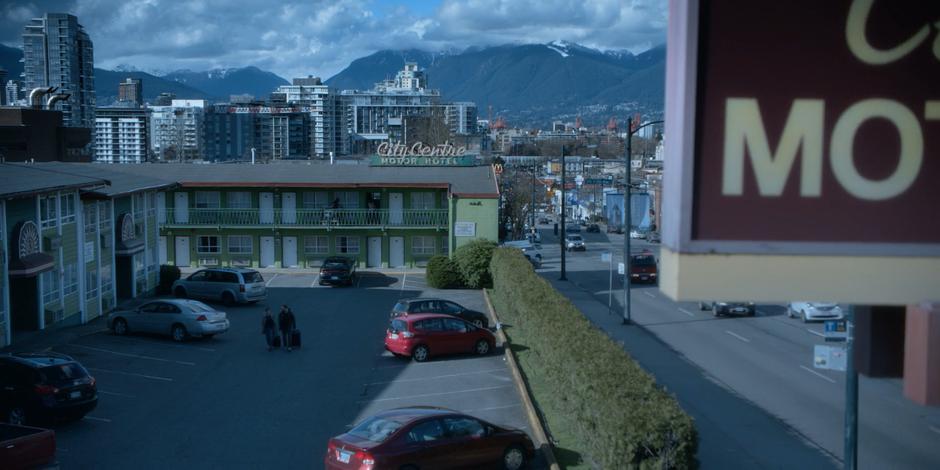 Establishing shot of the motel and parking lot.