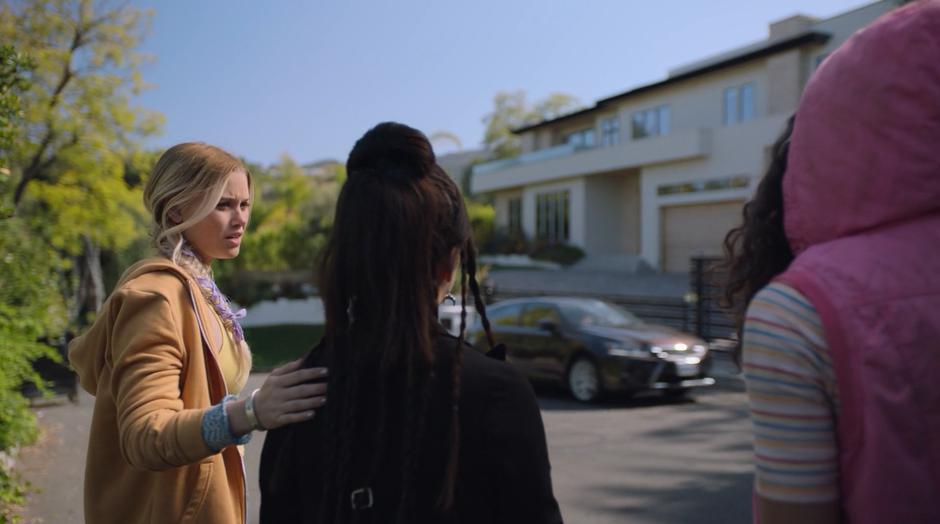 Karolina makes sure Nico is okay as they stand across the street from the house with Molly.