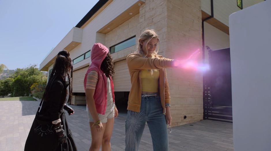 Nico and Molly look towards the house as Karolina uses her powers to overload the security system.