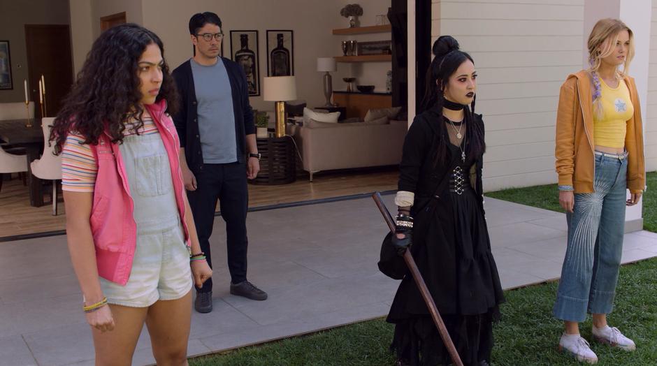 Robert stands behind Molly, Nico, and Karolina as they face off against his wife.