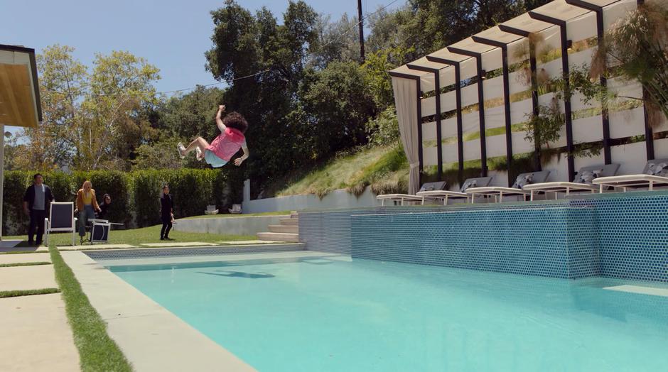 Molly is thrown through the air towards the pool by Tina as Robert, Karolina, and Nico watch.