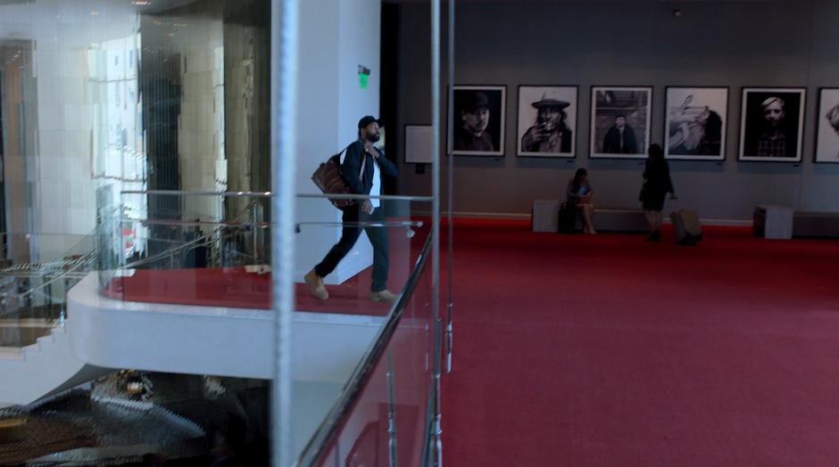 Darius walks through the upper floor of the hotel lobby.