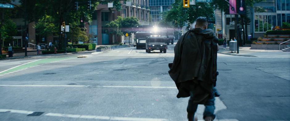 Cable's shot flies over the leading humvee towards the convoy truck following it.