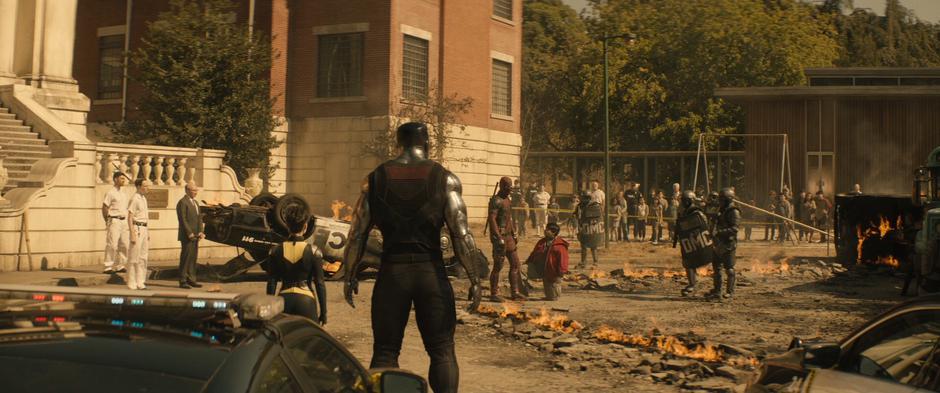 Wade looks over at Negasonic Teenage Warhead and Colossus as the police approach.
